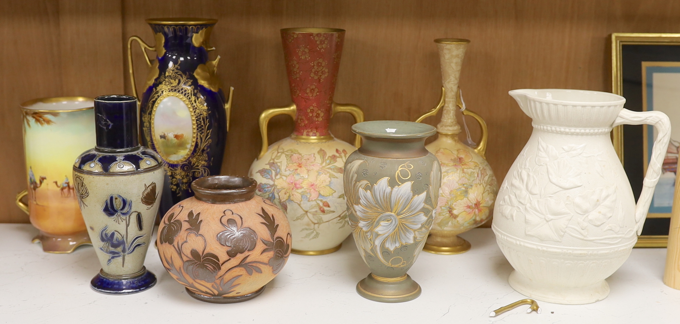 C.H Bailey - a Fulham vase (a.f.), two Doulton Burslem gilded vases, three other Doulton vases and a Victorian jug, largest 27cm high (7)